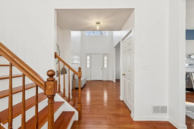 a view of entryway and hall with wooden floor