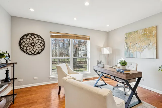 a front view of a house with a yard covered with snow in front of house