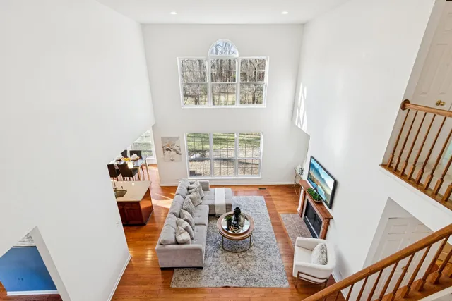 a view of a dining room with furniture next to a window