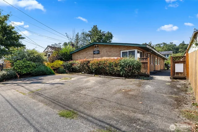 a front view of a house with a yard and potted plants