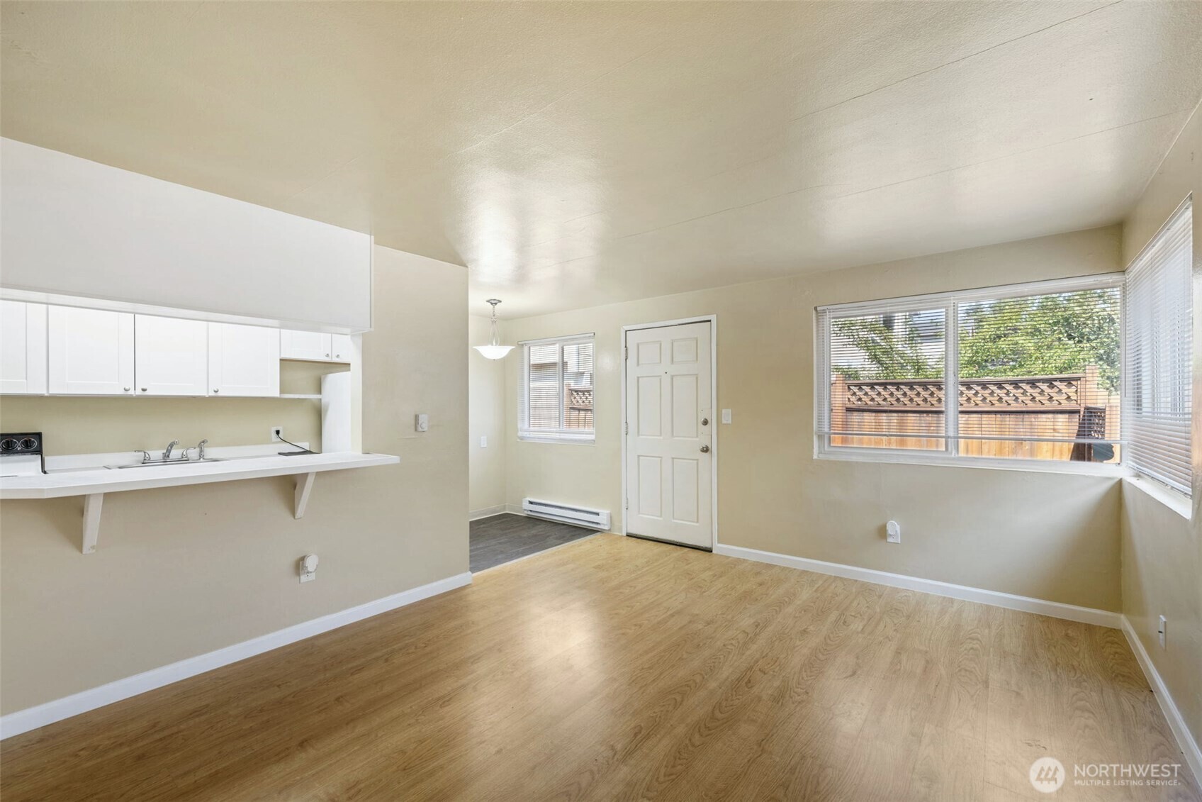 6705 Delridge Way Southwest Seattle, WA 98106 - Photo 8 of 21 a view of a kitchen with wooden floor and electronic appliances