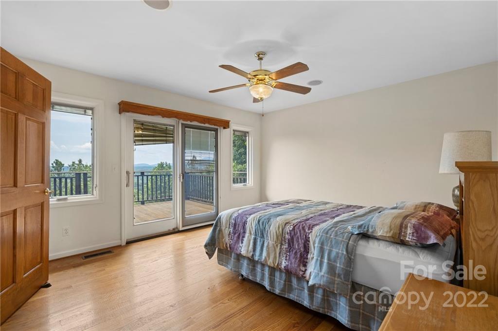 428 Smith Road Columbus, NC 28722 - Photo 14 of 48 a bedroom with a bed and a large window