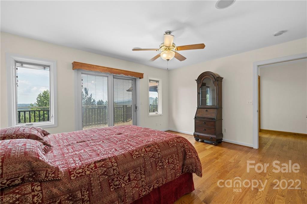 428 Smith Road Columbus, NC 28722 - Photo 16 of 48 a bedroom with a large bed and a large window