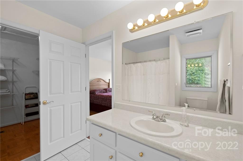 428 Smith Road Columbus, NC 28722 - Photo 17 of 48 a bathroom with a sink vanity granite tub and shower