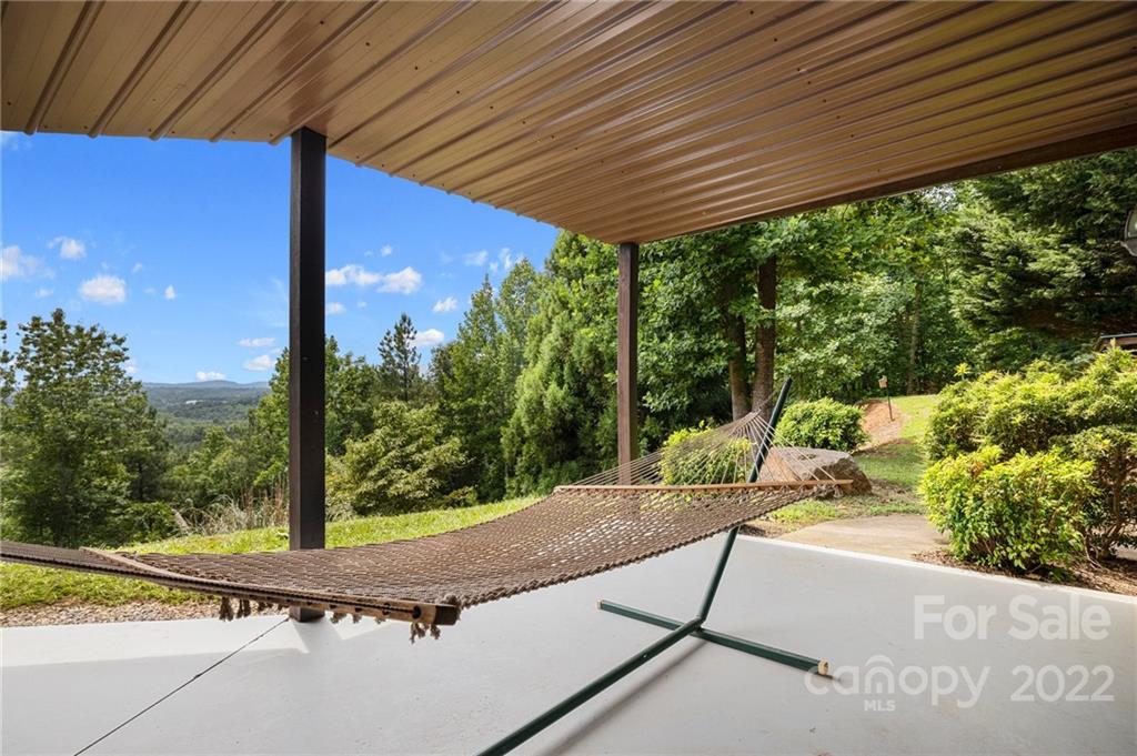 428 Smith Road Columbus, NC 28722 - Photo 28 of 48 a view of a patio with table and chairs under an umbrella