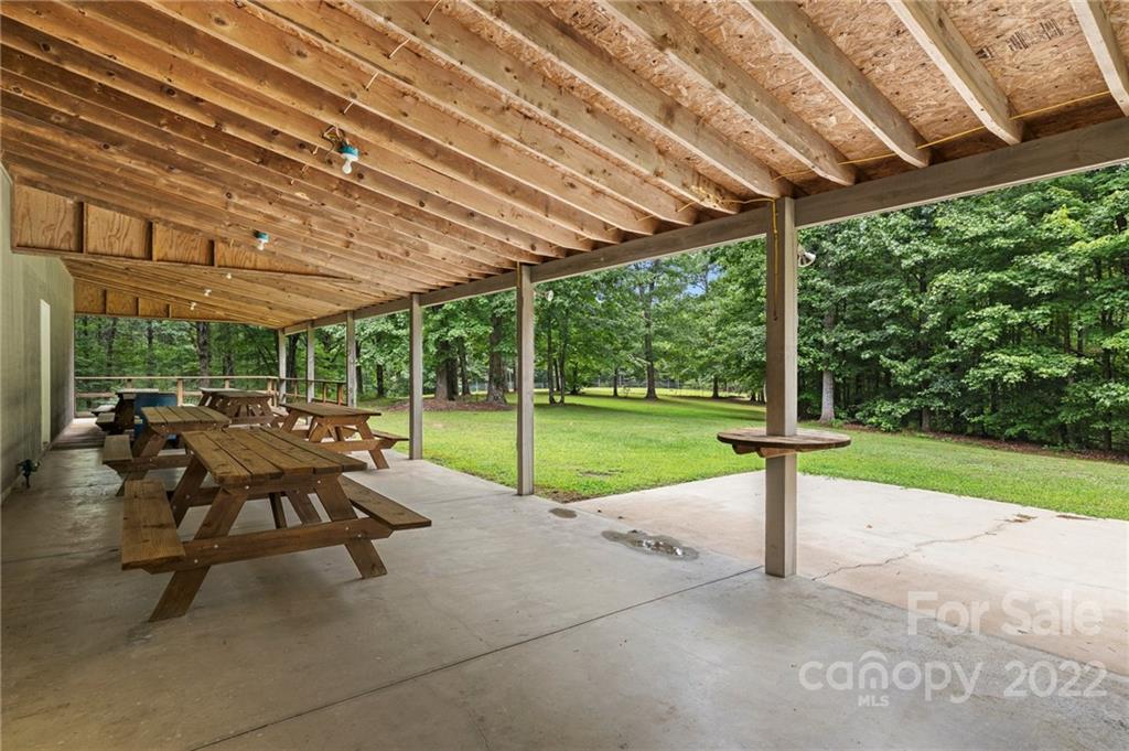 428 Smith Road Columbus, NC 28722 - Photo 29 of 48 a view of a patio with a table chairs and a small yard