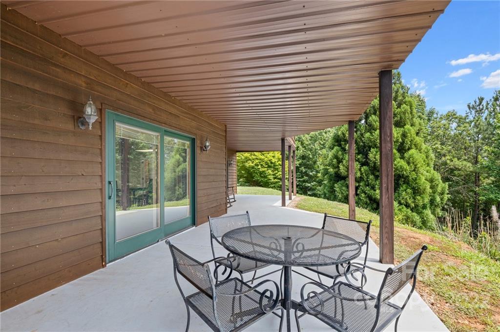 428 Smith Road Columbus, NC 28722 - Photo 30 of 48 a view of a patio with a table and chairs under an umbrella