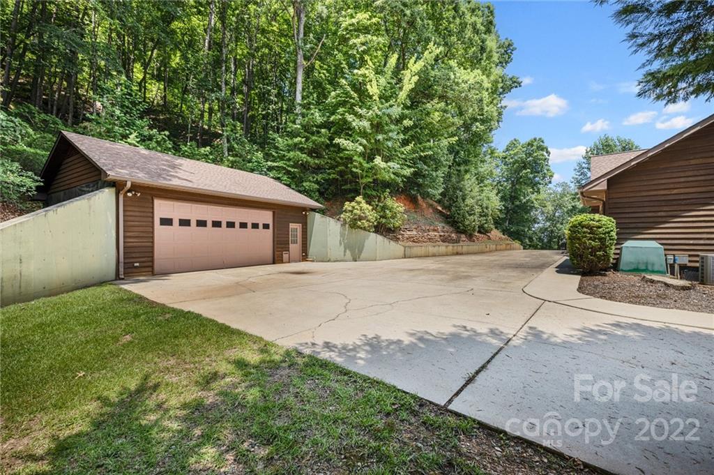 428 Smith Road Columbus, NC 28722 - Photo 32 of 48 a view of a house with a yard