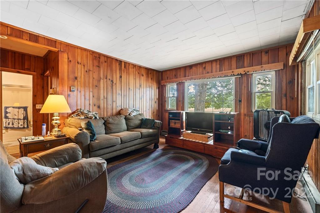 428 Smith Road Columbus, NC 28722 - Photo 37 of 48 a living room with furniture and a flat screen tv