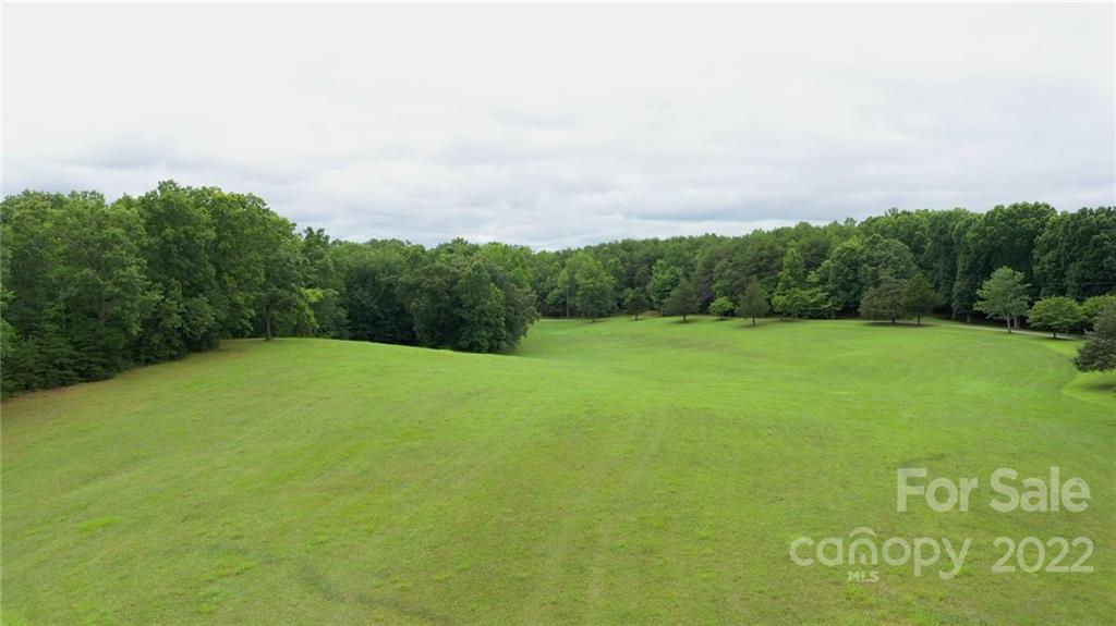 428 Smith Road Columbus, NC 28722 - Photo 5 of 48 a view of a field with trees in the background