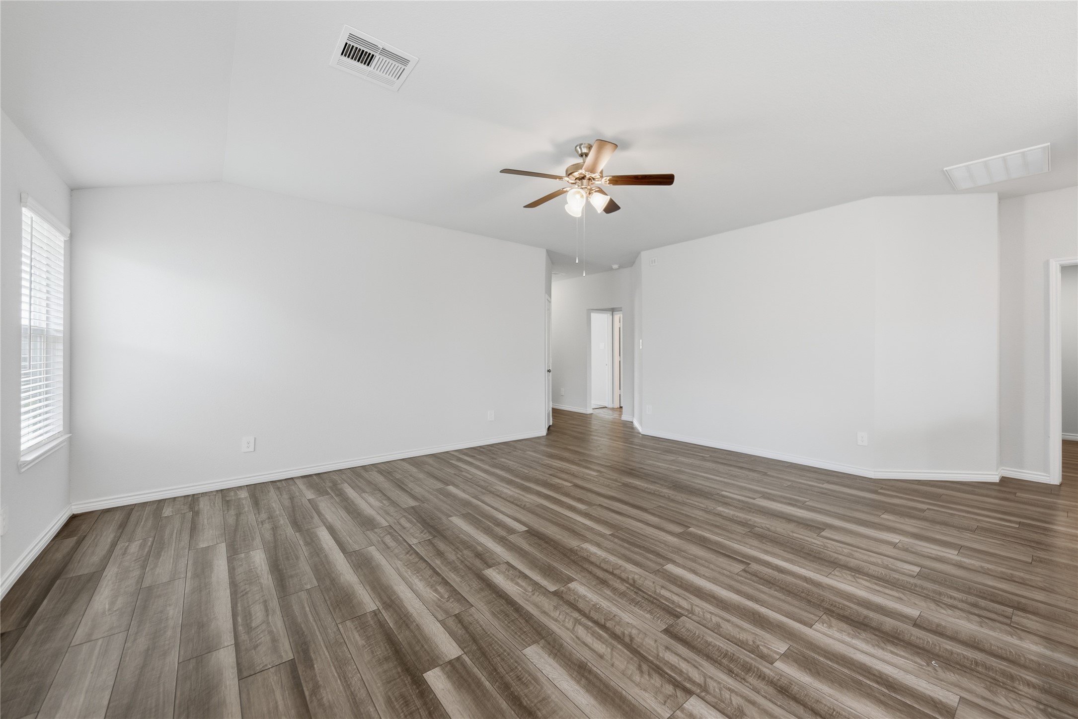 1010 Fannin Street Brenham, TX 77833 - Photo 19 of 30 a view of room with wooden floor and ceiling fan