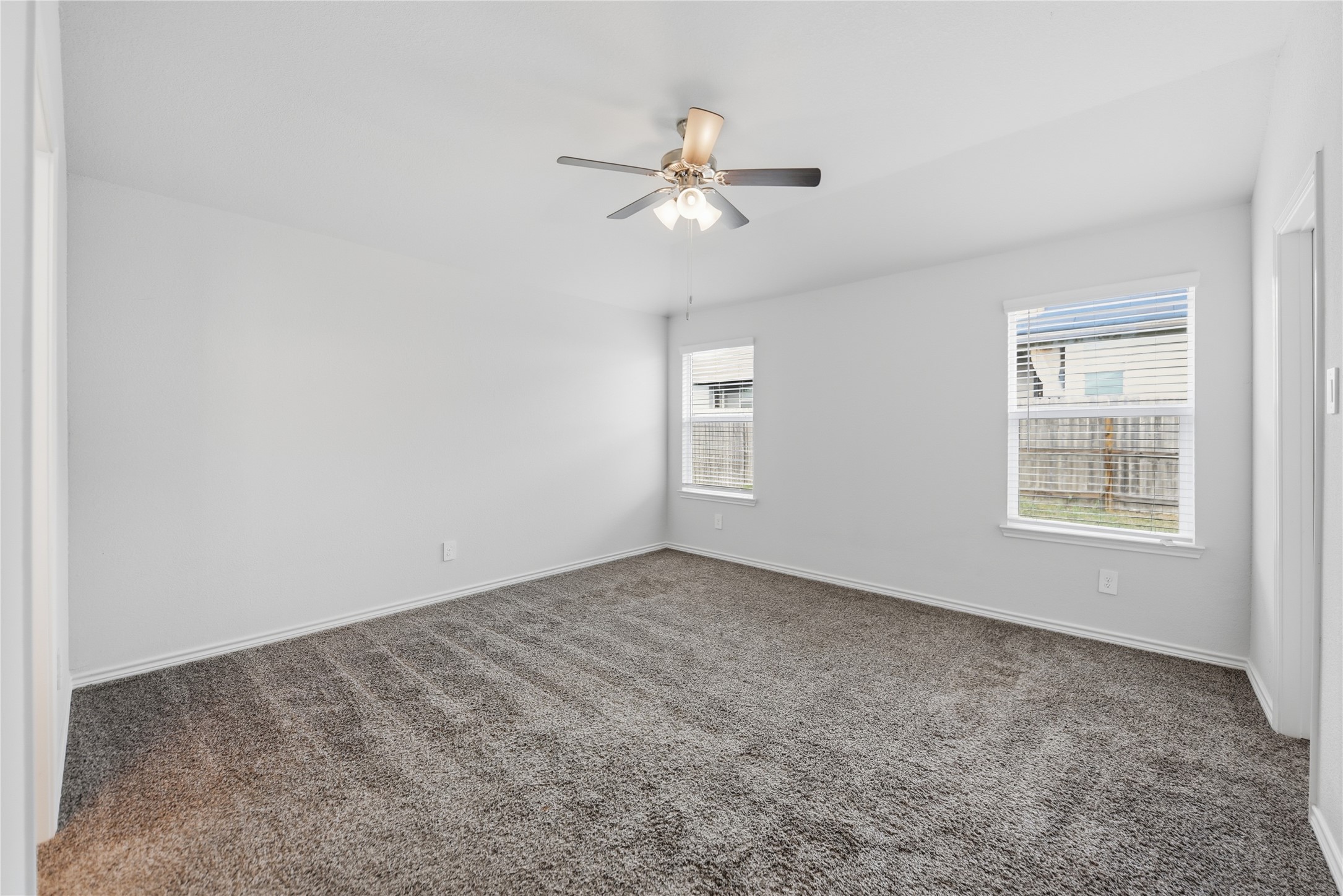 1010 Fannin Street Brenham, TX 77833 - Photo 21 of 30 an empty room with windows and fan