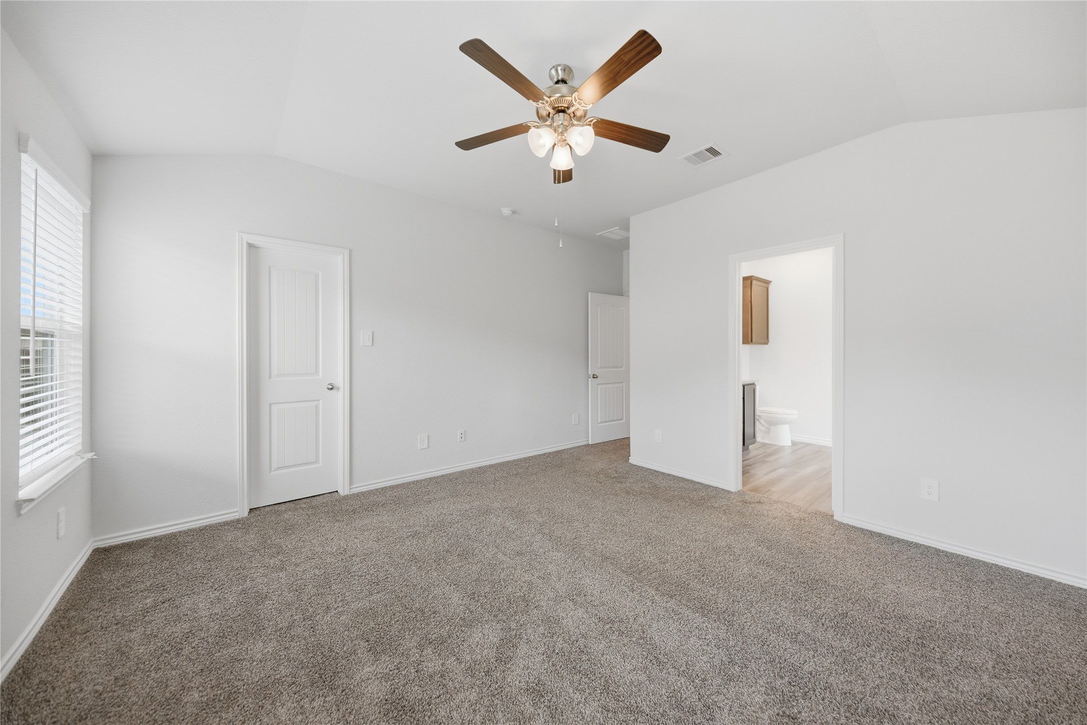 1010 Fannin Street Brenham, TX 77833 - Photo 22 of 30 an empty room with window and ceiling fan