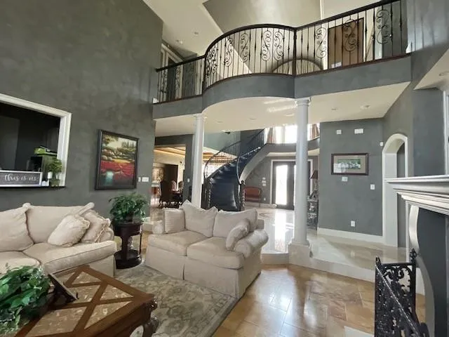 a living room with furniture a fireplace and a chandelier
