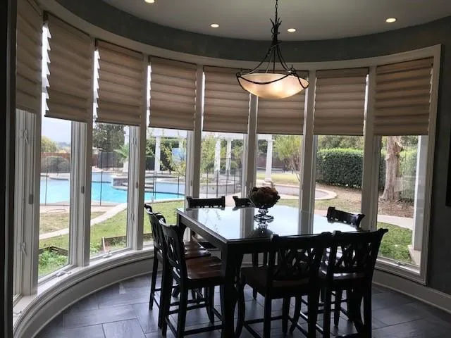 a dining area with furniture window and outdoor view