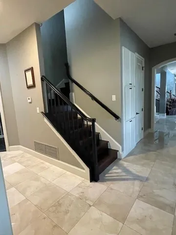 a view of entryway and hall with wooden floor