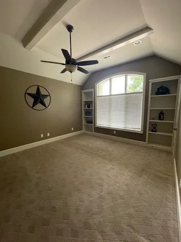 a view of a livingroom with a ceiling fan and window