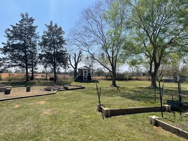 a view of a swimming pool with a yard