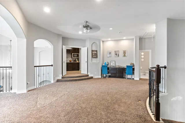 a view of a room with gym equipment and large windows