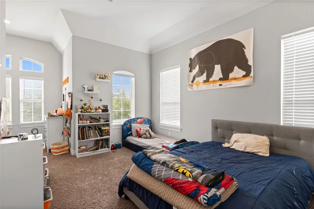 a bedroom with bed and a window