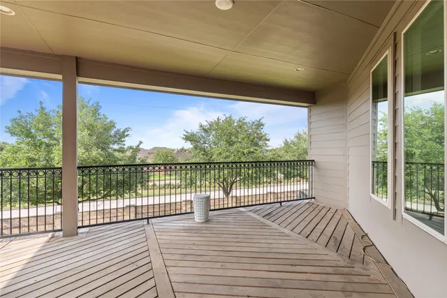 a view of a balcony with wooden floor