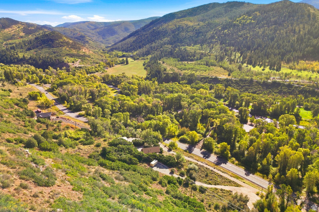 2640 East Weber Canyon Road Oakley, UT 84055 - Photo 10 of 56 Mountainous terrain with lush green vegetation and a winding road