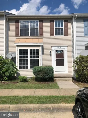 a front view of a house with a yard and a garage