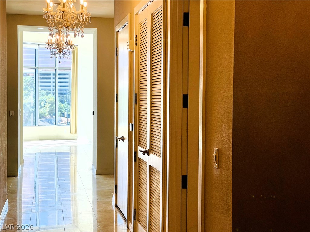 360 East Desert Inn Road, Unit 507 Las Vegas, NV 89109 - Photo 28 of 37 Gleaming tile floors guide the way through a classic hallway framed by high ceilings.