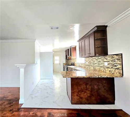 a kitchen with stainless steel appliances granite countertop a stove sink and cabinets