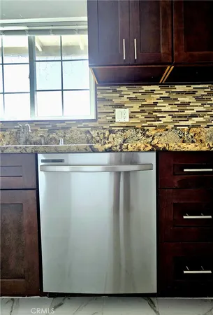 a bathroom with a granite countertop sink mirror and bathtub