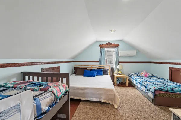 a bedroom with furniture and a wooden floor