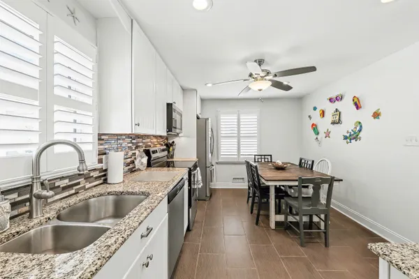 a kitchen with stainless steel appliances a stove sink microwave and cabinets