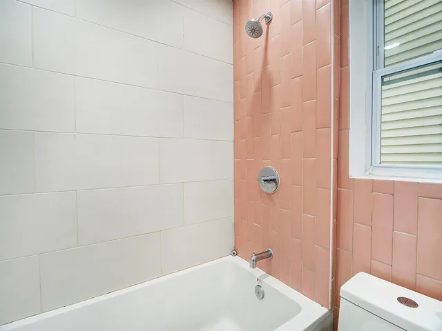 a bathroom with a tub and a shower