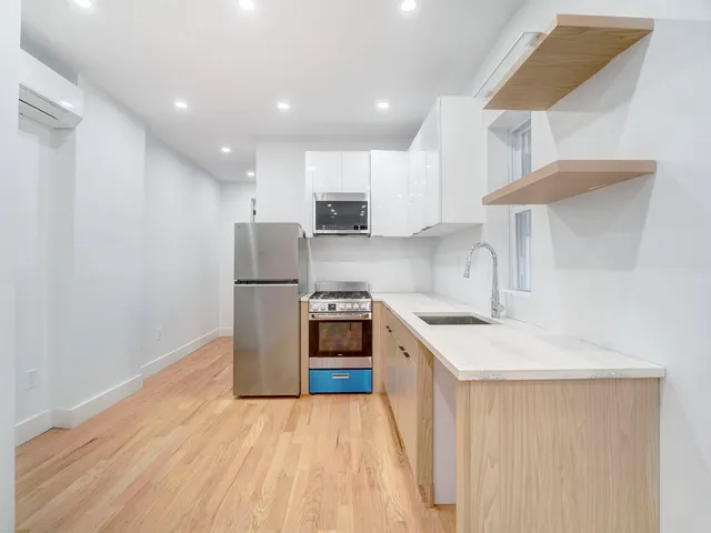 a kitchen with a sink a stove and a refrigerator