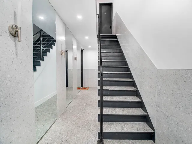 a view of entryway with wooden floor and white walls