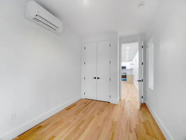 a view of a room with wooden floor
