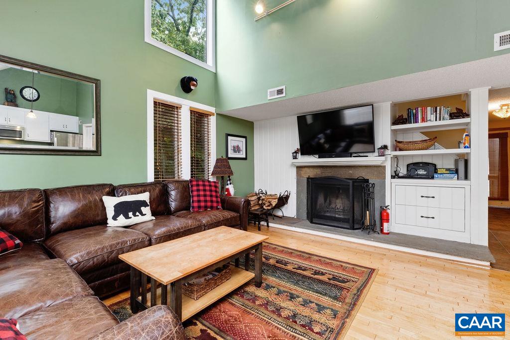 433 3 Ridges Roseland, VA 22967 - Photo 8 of 22 a living room with furniture a flat screen tv and a fireplace