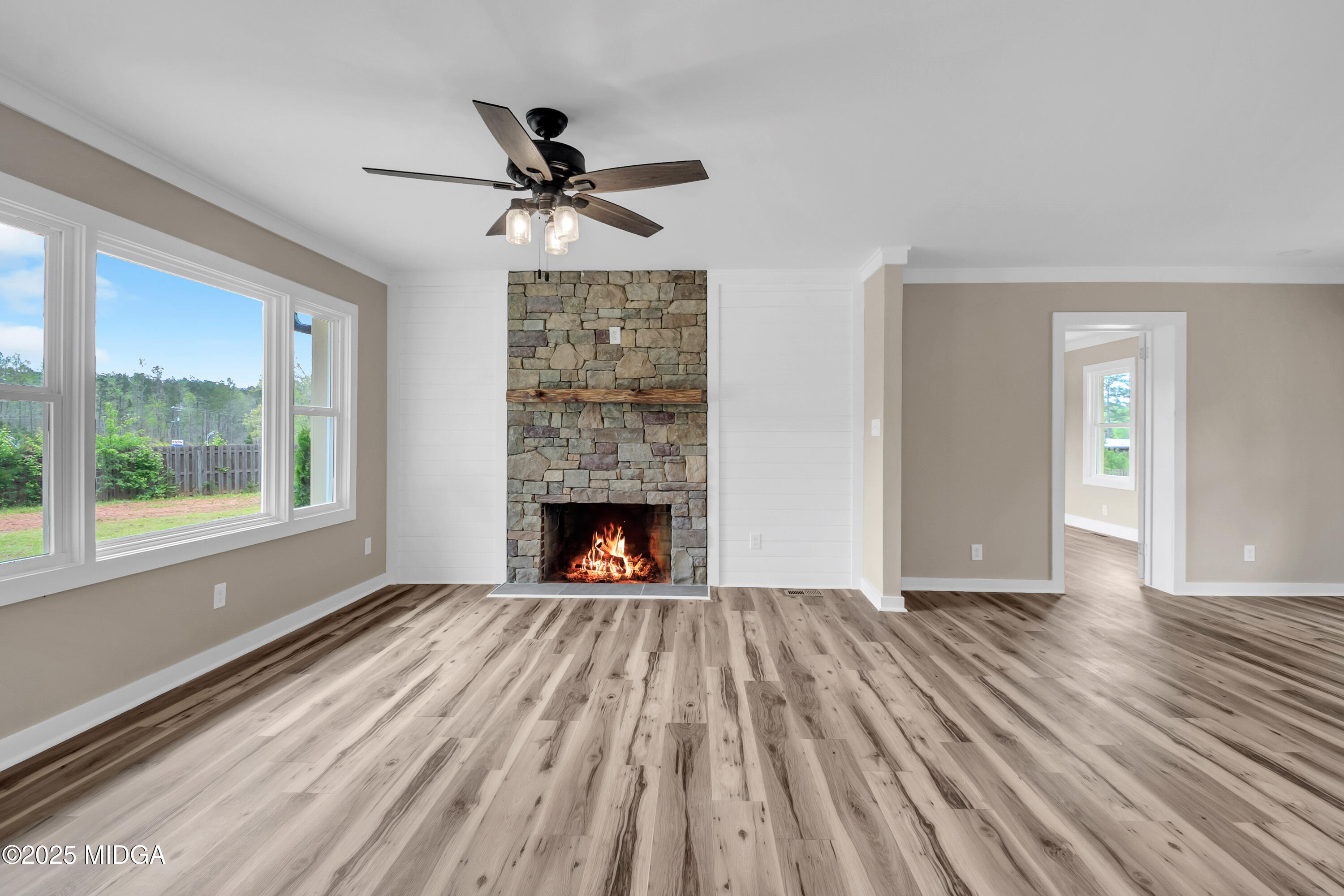 8738 Highway 87 Juliette, GA 31046 - Photo 13 of 36 a view of empty room with wooden floor fireplace and windows