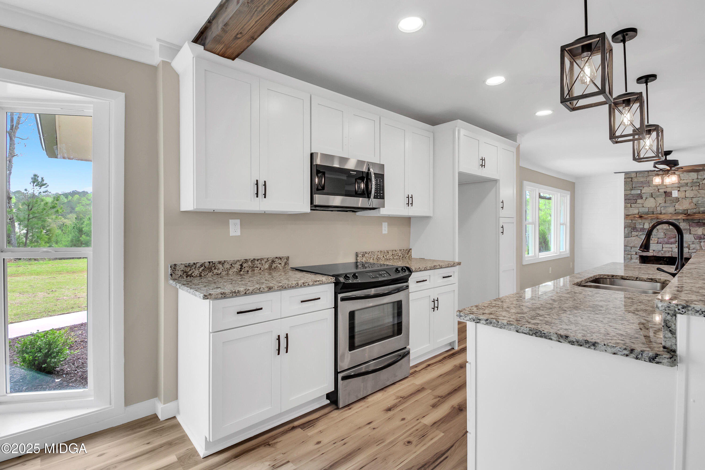 8738 Highway 87 Juliette, GA 31046 - Photo 17 of 36 a kitchen with granite countertop a sink stove and refrigerator