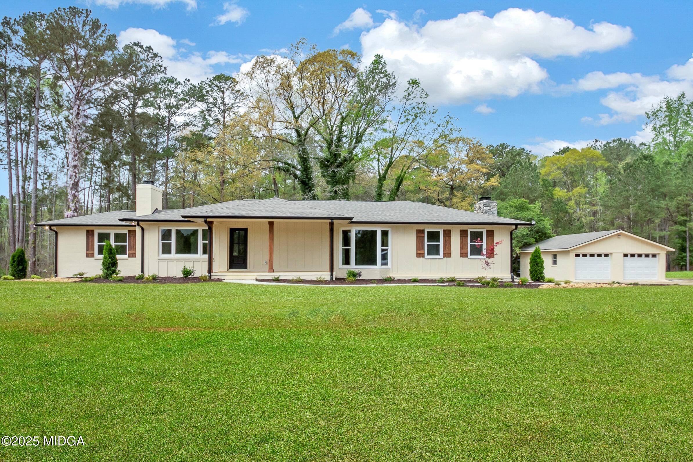 8738 Highway 87 Juliette, GA 31046 - Photo 2 of 36 a front view of a house with a garden