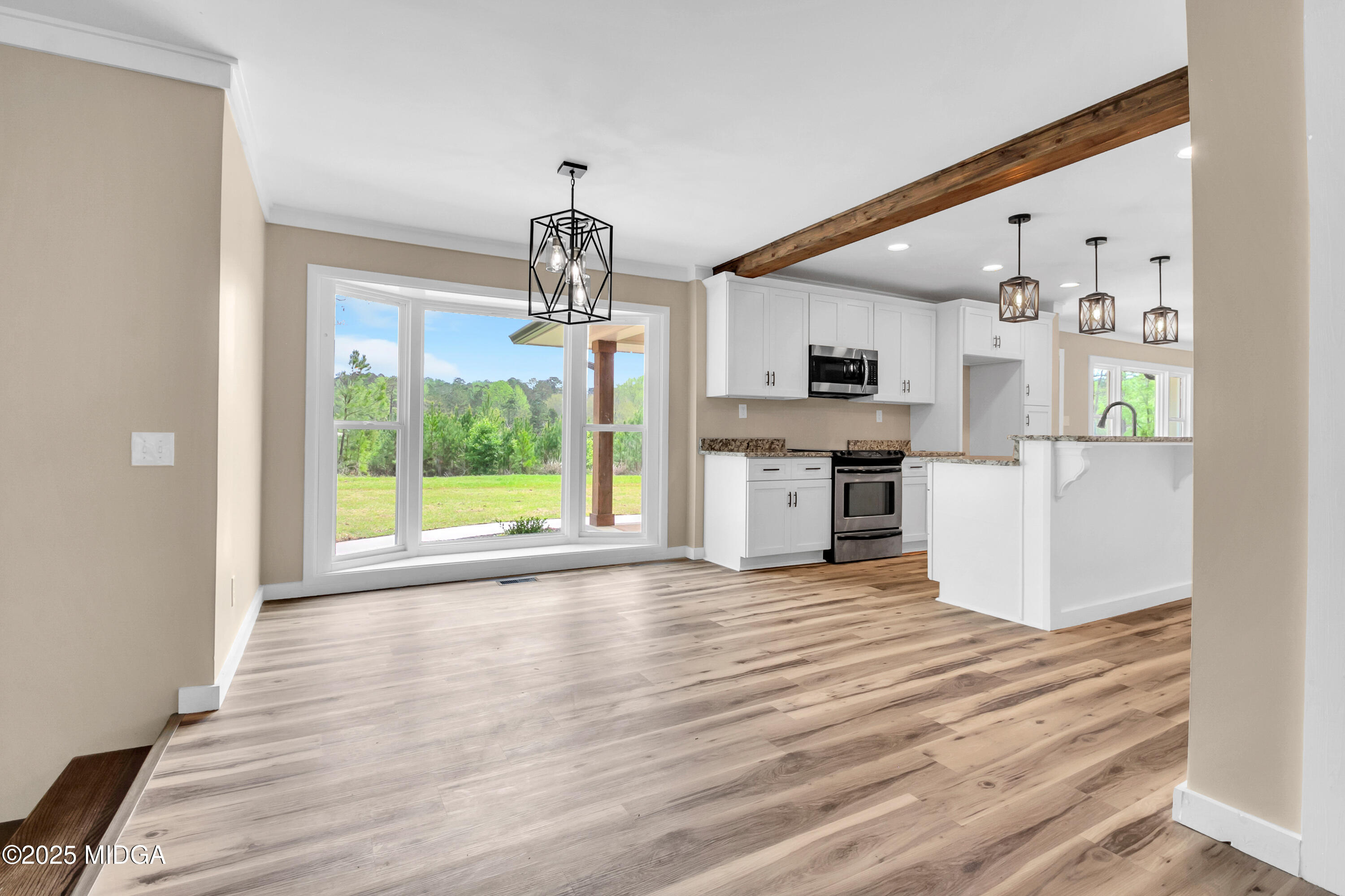 8738 Highway 87 Juliette, GA 31046 - Photo 22 of 36 a view of a kitchen with furniture and wooden floor