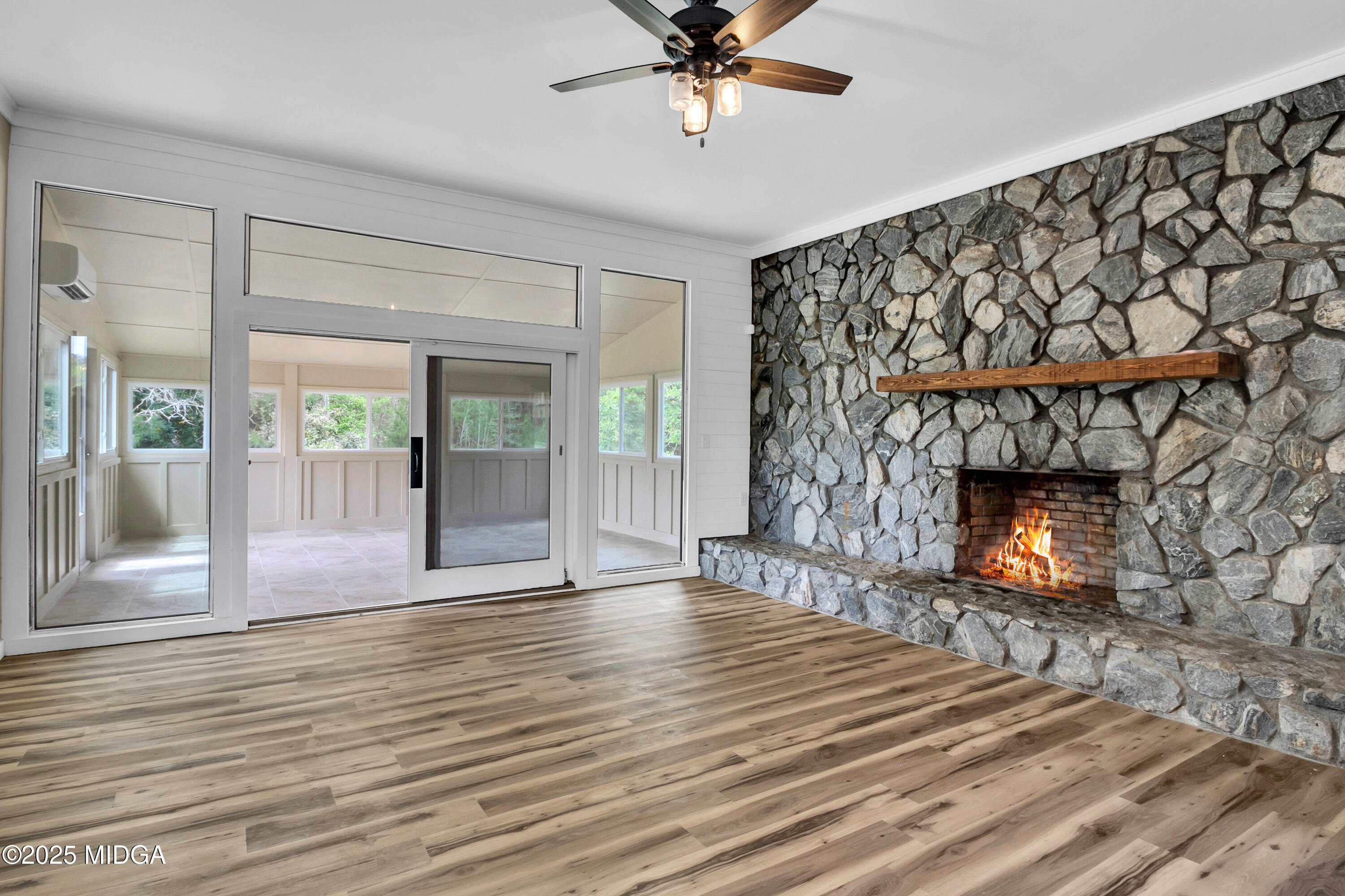 8738 Highway 87 Juliette, GA 31046 - Photo 23 of 36 a view of an empty room with wooden floor and a fireplace