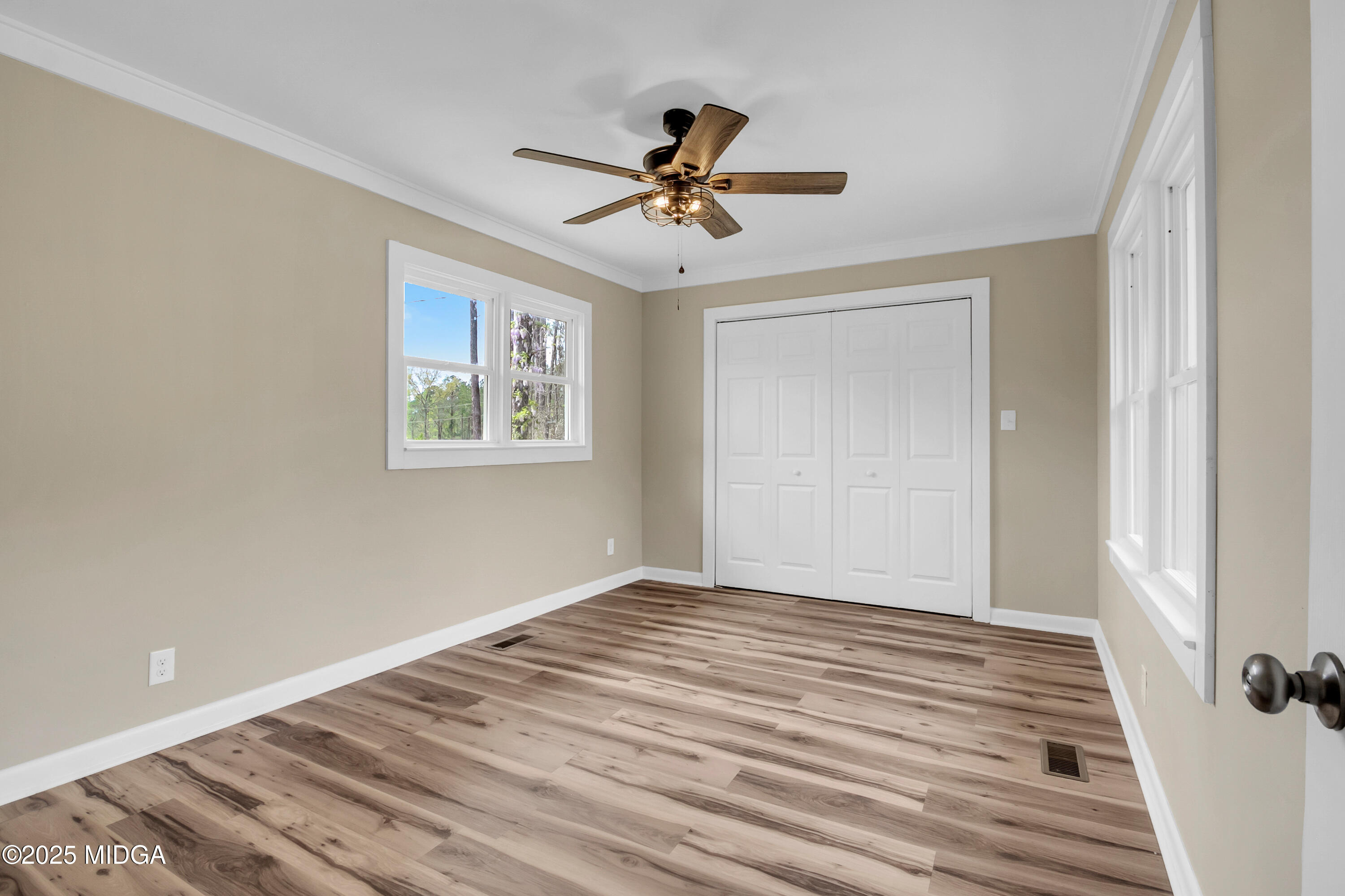 8738 Highway 87 Juliette, GA 31046 - Photo 33 of 36 a view of a livingroom with wooden floor and a ceiling fan