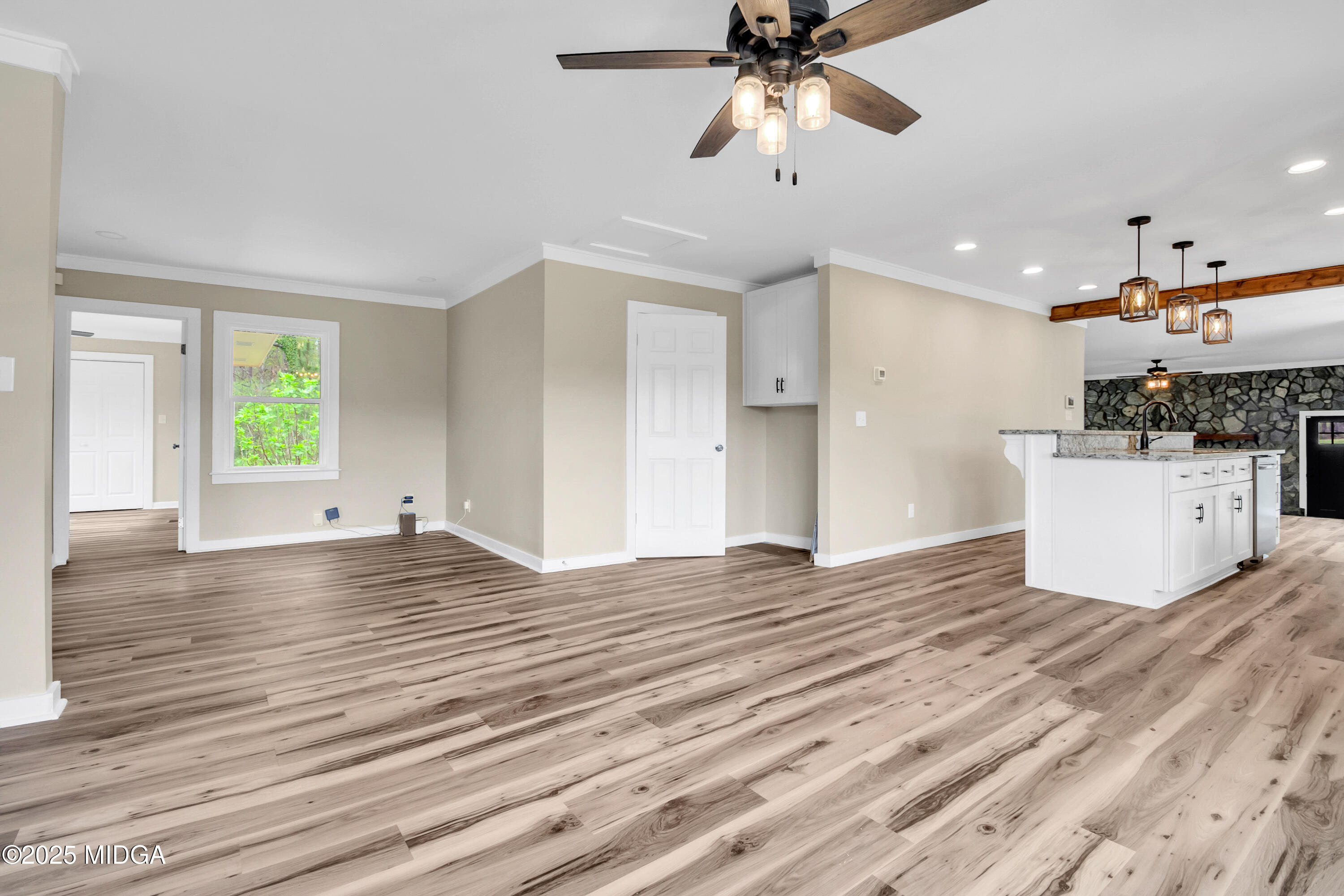 8738 Highway 87 Juliette, GA 31046 - Photo 10 of 36 a view of a kitchen with wooden floor and a ceiling fan