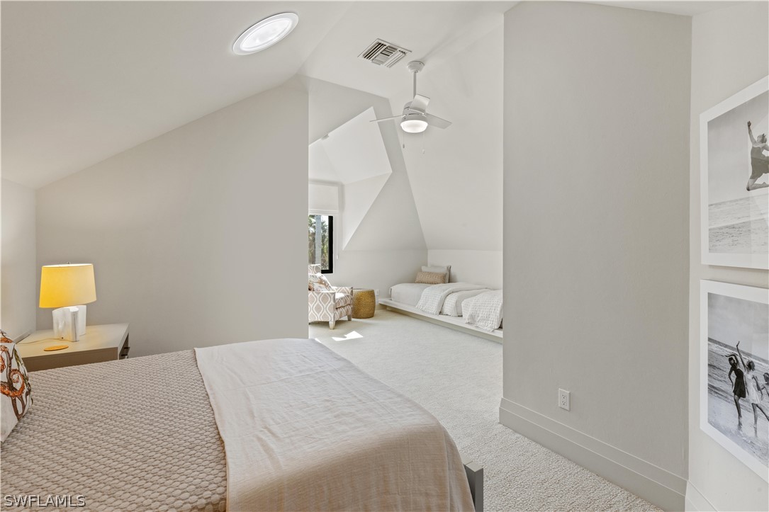 2564 Wulfert Road Sanibel, FL 33957 - Photo 29 of 50 a bedroom with a bed and a chandelier