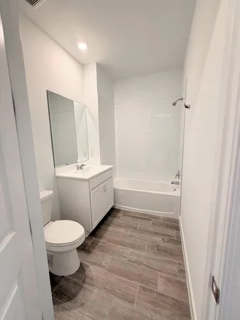 a bathroom with a sink a toilet a mirror and vanity