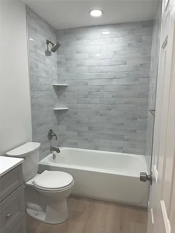 a bathroom with a toilet a sink and bathtub