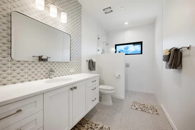 a bedroom with a bed and a night stand