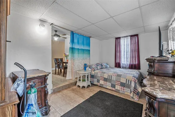 a bedroom with a bed and paintings on the wall