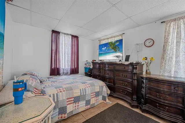 a spacious bedroom with a large bed and a couch